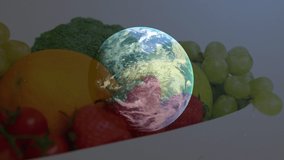 Animation of globe over plate with fruits and veggies. Food, fruits, vegetable and world vegan day concept digitally generated video.