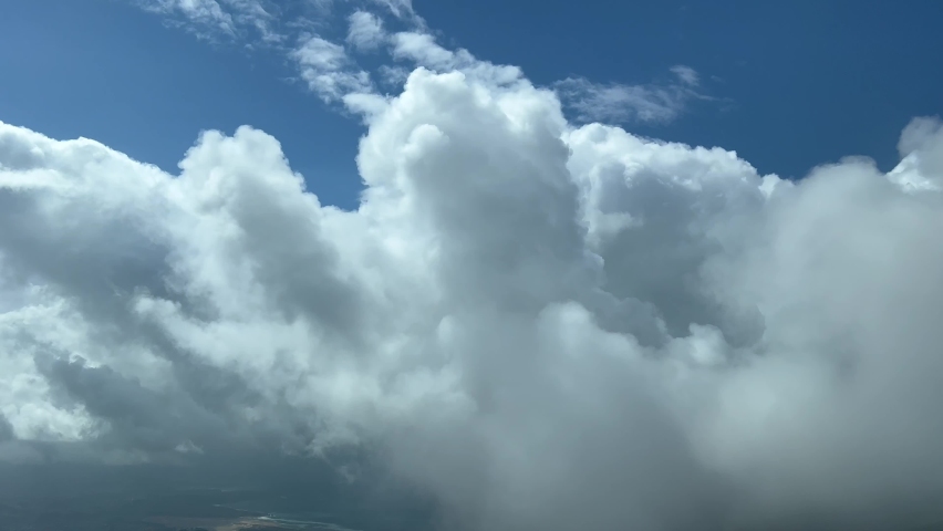Impressive view from a jet cockpit flying at 12000 metres high while penetrating some very high stormy clouds. Pilot POV. 4K 60fps. Royalty-Free Stock Footage #1093623771
