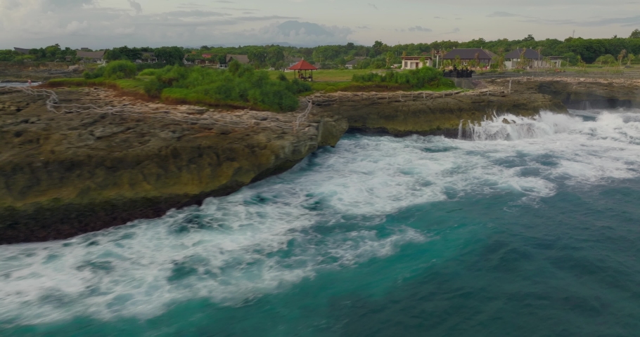 Powerfull waves rolling into tourist spot Devil's tears on rocky coastline of Nusa lembongan