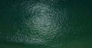 Nature video Aerial view top-down view blue ocean wave texture water surface. ProRes HQ 4:2:2 Nature and Go Everywhere travel concept.