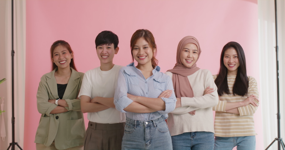 Diverse group of young asia Gen z girl arm cross happy face look at camera in model shooting studio shot. Power of people woman's day right or gay youth LGBT pride unity team strong cool proud smile. | Shutterstock HD Video #1093638387