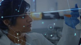 Animation of data processing over biracial female doctor with beaker. Global business and digital interface concept digitally generated video. - Powered by Shutterstock - Get 15% off with code: PIKWIZARD15