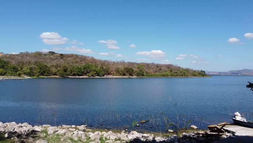 Aerial shot of blue lake with sky and clouds