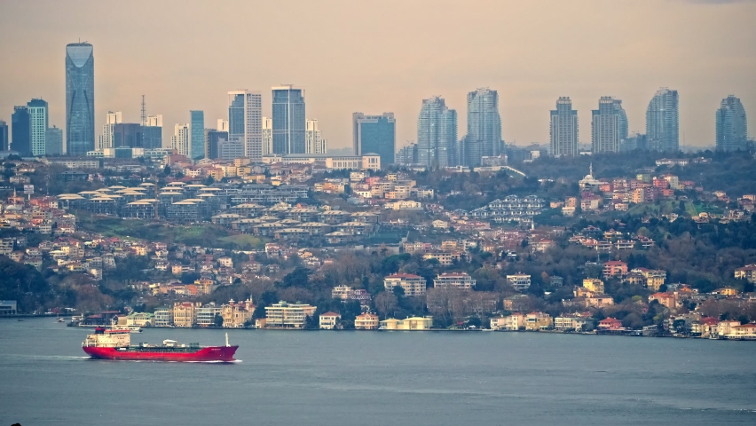 Life and ships, maritime traffic on the shores of an island with traditional and modern houses. Ferries sail along bosphorus. Endless rows of houses and majestic mosques. İstanbul, Turkey.