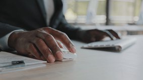 Close up unknown african american programmer businessman web designer work in IT company typing on modern keyboard use pc mouse organizing daily online tasks programming developing internet software - Powered by Shutterstock - Get 15% off with code: PIKWIZARD15