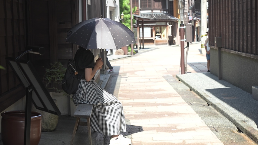 Asian woman strolling through Higashi Chaya District