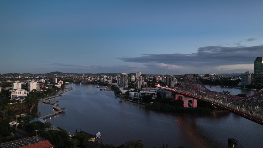 Aerial footage of Brisbane City and Story Bridge, taken at sunset. River and city skyline views. Brisbane, Queensland, Australia