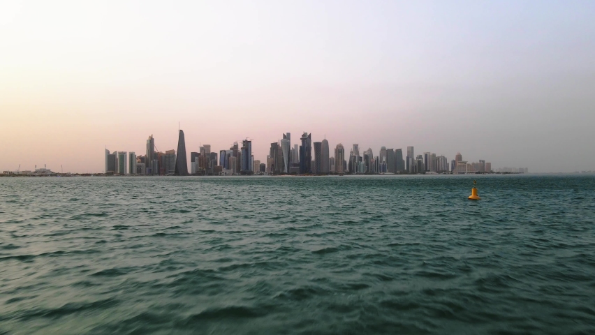 Drone shot over water moving toward Qatar Royalty-Free Stock Footage #1093655605
