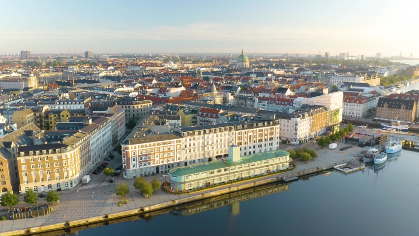 Cinematic Aerial View of Famous Nyhavn Harbour in Copenhagen, Denmark at Sunrise. Royalty-Free Stock Footage #1093655649