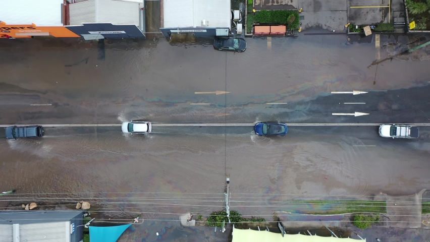 Top down view of cars crossing flooded road. Brisbane Floods Drone  | Shutterstock HD Video #1093656501