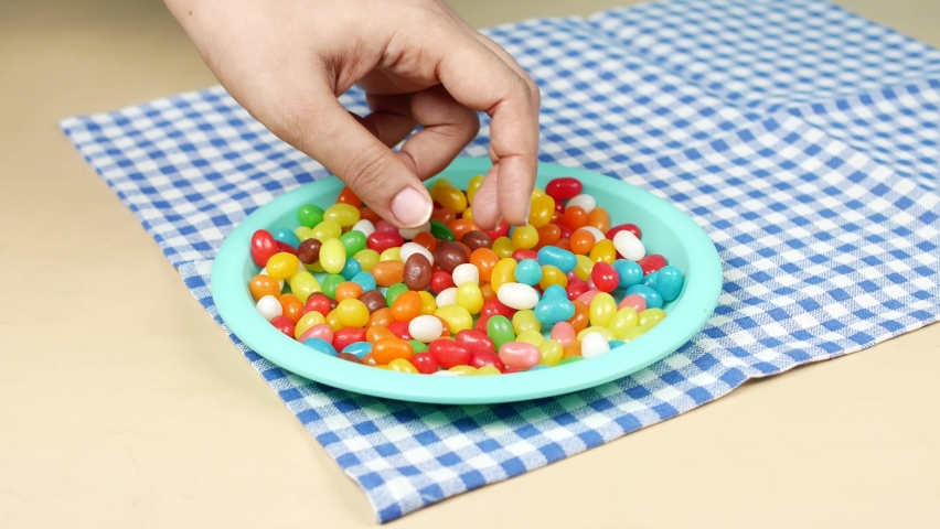 hand pick Jelly beans on plate 