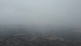 Beautiful Aerial Footage of British Town from Low Level Rain Clouds. 