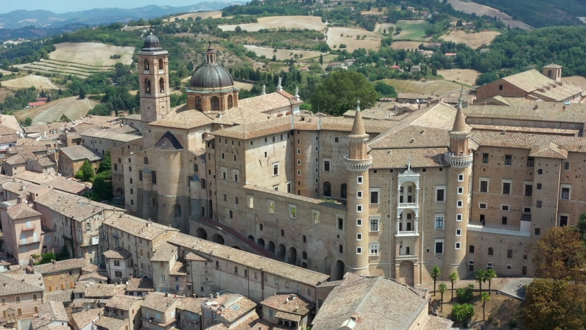 Aerial view of Urbino with the Ducal Palace of Urbino built by Federico da Montefeltro in the center. Urbino, Pesaro and Urbino, Italy  Royalty-Free Stock Footage #1093668959