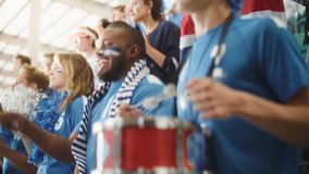 Sport Stadium Big Event: Handsome Black Man Cheering. Crowd of Fans with Painted Faces Cheer, Shout for the Blue Soccer Team to Win. People Celebrate Scoring a Goal, Championship Victory. Slow Motion - Powered by Shutterstock - Get 15% off with code: PIKWIZARD15