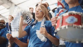 Sport Stadium Big Event: Crowd of Fans Cheer for their Blue Soccer Team to Win. People Celebrate Scoring a Goal, Championship Victory. Cute Young Couple with Painted Faces Cheer, Hug. Slow Motion - Powered by Shutterstock - Get 15% off with code: PIKWIZARD15