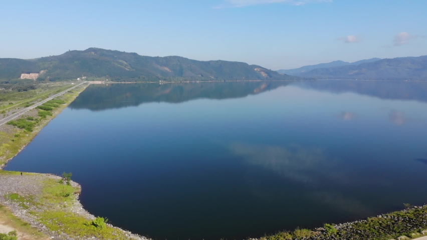 Morning sunrise on river dam with mountain aerial movement view nature scene
