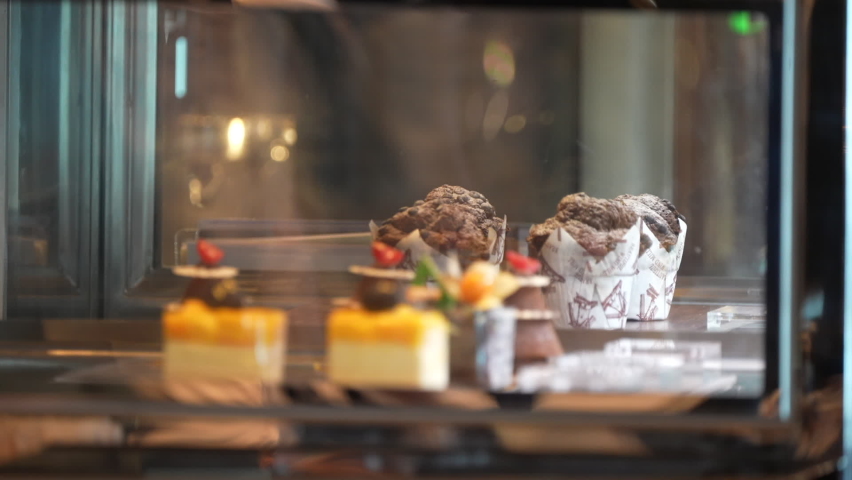 cupcakes cheesecakes and more in shelf sweets corner in glass focus shift