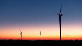 The first stars in the sky above a field of wind turbines. Beautiful time-lapse between day and night - Powered by Shutterstock - Get 15% off with code: PIKWIZARD15