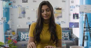Young Pretty  Latin American Business Woman Opening Laptop Computer at Home Office. Holographic Social Media Interface Animations Appearing. Social Network. Likes, Comments, Followers. 