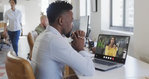 Animation of african american man having video call on laptop. Business, communication and working in office with technology concept.