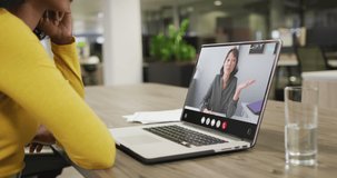 Animation of biracial woman having video call on laptop. Business, communication and working in office with technology concept.