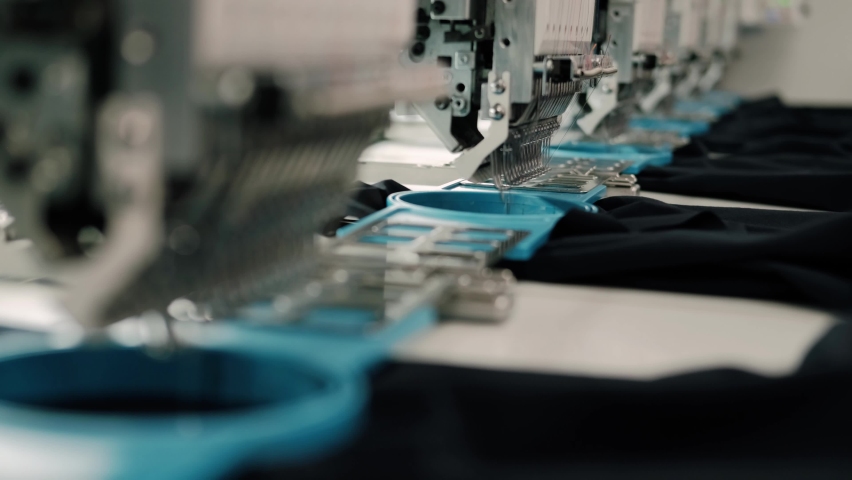 Modern and automatic high technology sewing machine for textile or clothing apparel making manufacturing process in industrial. Close up Computerized embroidery machines Royalty-Free Stock Footage #1093678019