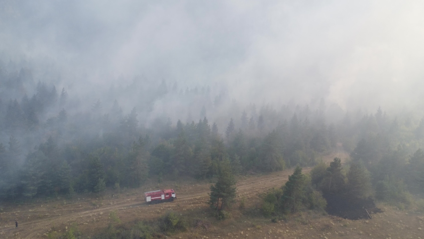 A fire engine is trying to put out the fire in the forest - 
Fire in Borjomi
 Royalty-Free Stock Footage #1093682185
