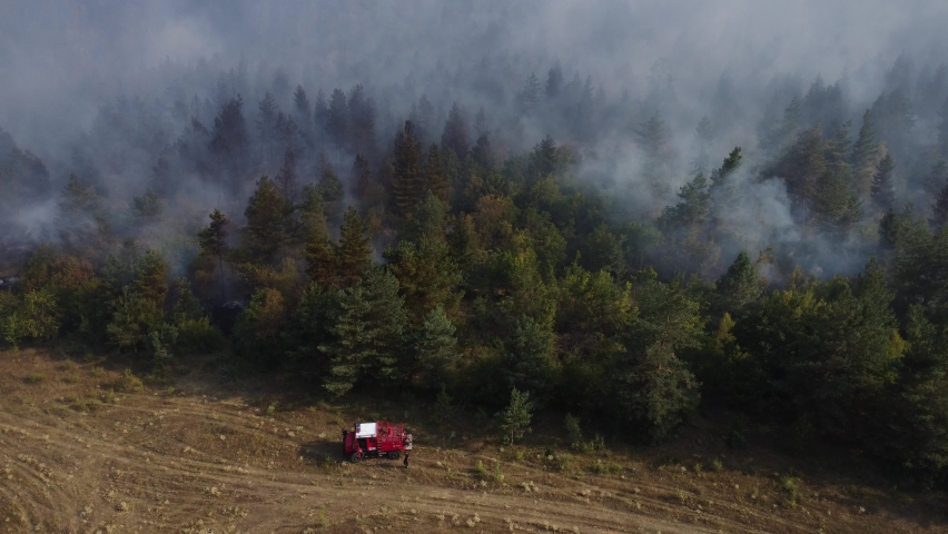 A fire engine is trying to put out the fire in the forest - 
Fire in Borjomi
 Royalty-Free Stock Footage #1093682197