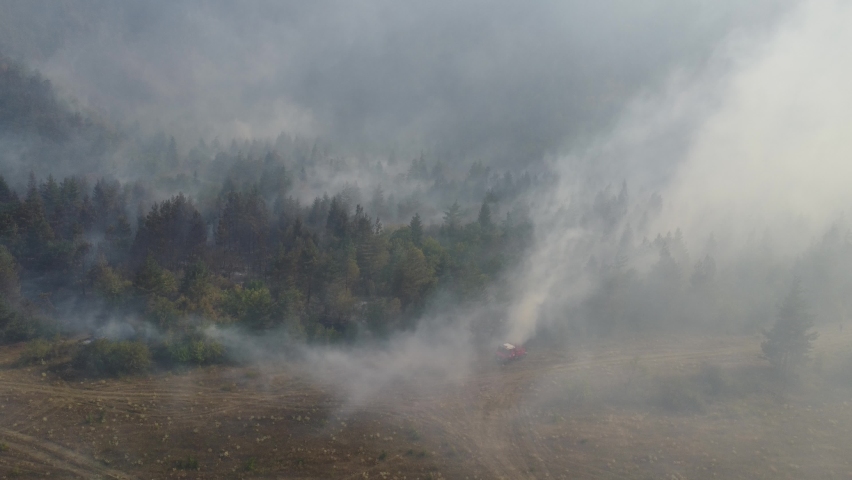 A fire engine is trying to put out the fire in the forest - 
Fire in Borjomi
 Royalty-Free Stock Footage #1093682203