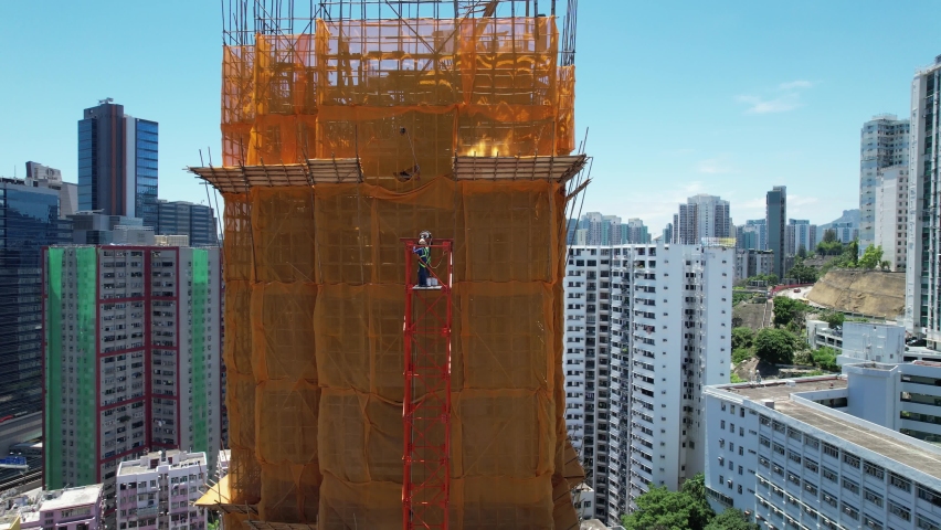 Commercial and residential construction development project in Kwun Tong of Hong Kong city, becoming the newest business district near Kowloon Bay and Victoria harbor, Aerial drone skyview | Shutterstock HD Video #1093683529