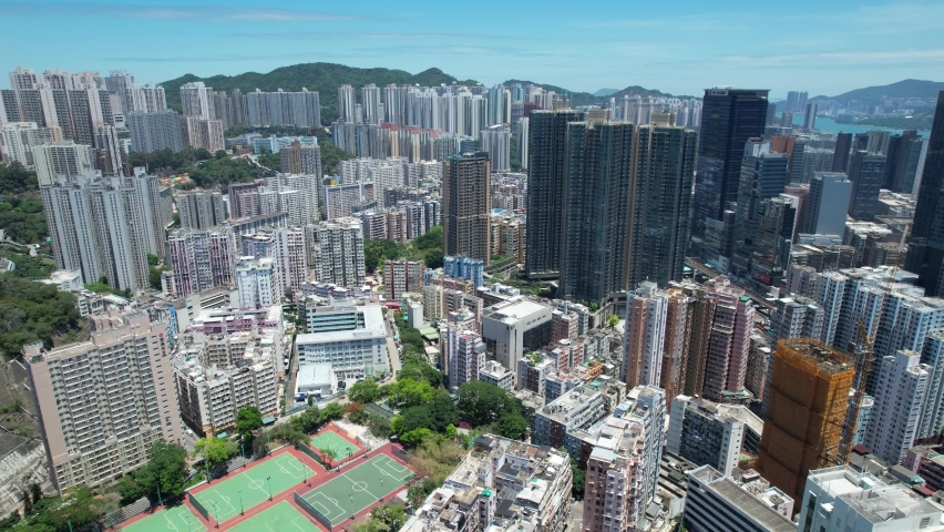 Commercial and residential construction development project in Kwun Tong of Hong Kong city, becoming the newest business district near Kowloon Bay and Victoria harbor, Aerial drone skyview | Shutterstock HD Video #1093683545