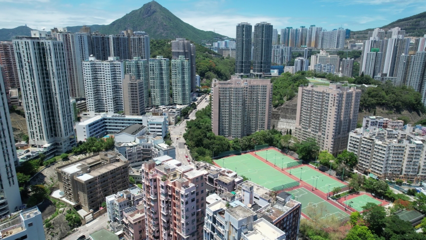 Commercial and residential construction development project in Kwun Tong of Hong Kong city, becoming the newest business district near Kowloon Bay and Victoria harbor, Aerial drone skyview | Shutterstock HD Video #1093683561