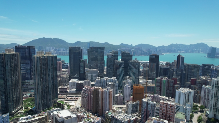 Commercial and residential construction development project in Kwun Tong of Hong Kong city, becoming the newest business district near Kowloon Bay and Victoria harbor, Aerial drone skyview | Shutterstock HD Video #1093683573