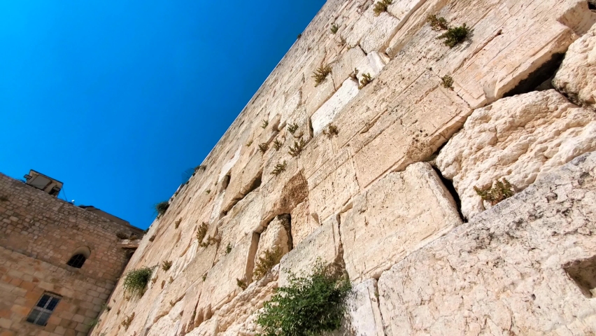Israel, Sacred Western Wall Kotel in Jerusalem Old City known as Wailing Wall and Al Buraq Wall. A holly place for Islam and Jewish religions. Royalty-Free Stock Footage #1093685881