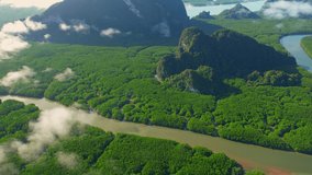 4K : Drone flying above the cloud and fog during sunrise, mangrove forests and rivers at Phang Nga Bay in tropical sea. Samed Nang Chee. Phang Nga Province, Southern Thailand. beauty of nature concept