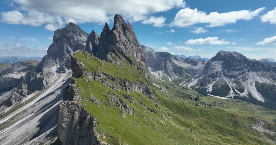 The Dolomites mountain range Italy part of the Southern Limestone Alps. Mountain aerial Hiking trekking majestic rugged cliffs with green grass. Unesco world heritage landscape. Dramatic mountain