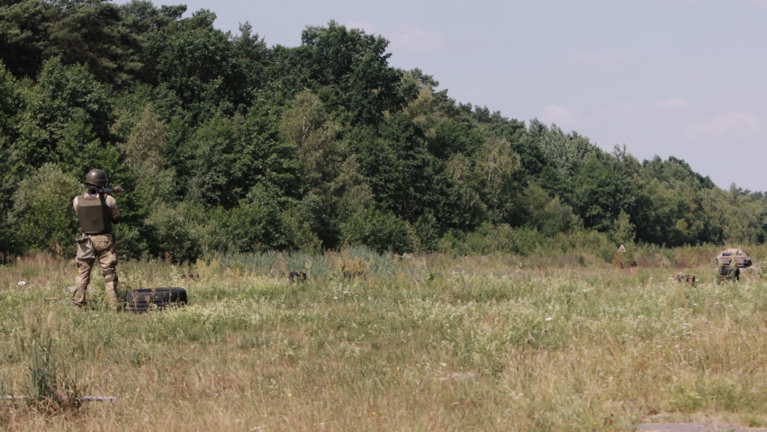 The soldier is wearing a helmet, uniform, and body armor when he fires a Precision Shoulder-Fired Rocket Launcher RPG-7 PSRL-1 at his enemy with a rocket that is precisely on target.