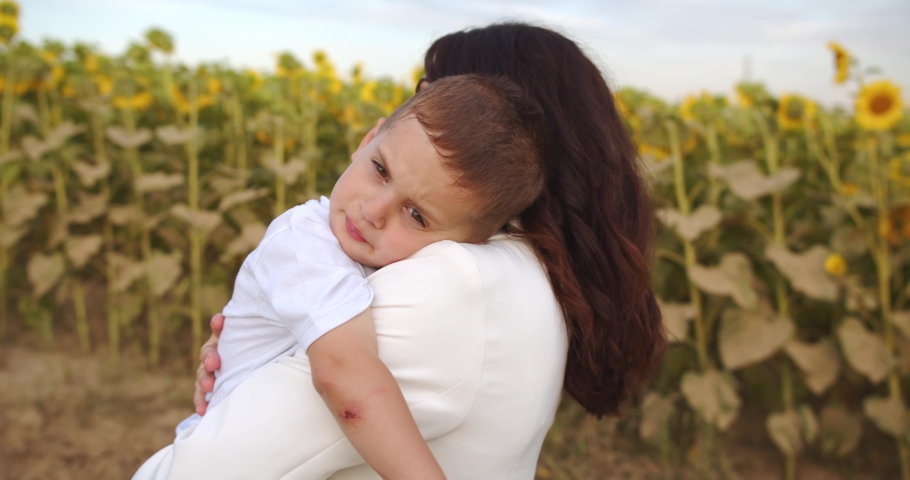 A tired child sleeps in his mother