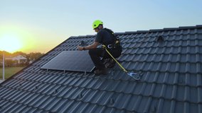 Engineer checking data on tablet, while installing solar panels on a private house roof - Aerial view - Powered by Shutterstock - Get 15% off with code: PIKWIZARD15