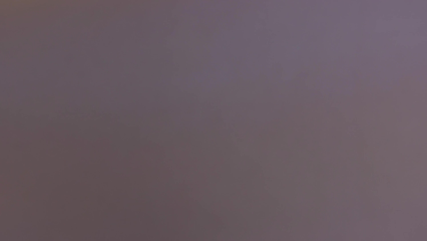 A man running to the cliff edge and spreading his hands