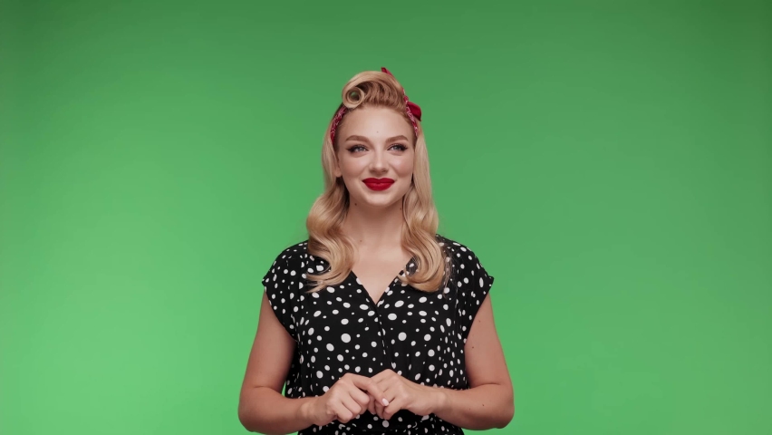attractive blond woman with red lips in retro dress Moving hands. Exited pin up Girl. Pop art style woman. Female posing isolated on chroma key background in studio. Youth millennial lifestyle concept Royalty-Free Stock Footage #1093712127