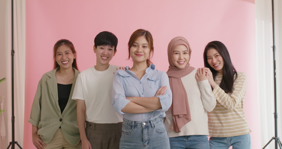 Diverse group of young asia Gen z girl arm cross happy face look at camera in model shooting studio shot. Power of people woman's day right or gay youth LGBT pride unity team strong cool proud smile. | Shutterstock HD Video #1093712283