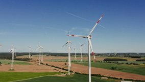 Bird's eye view of the rotating blades of a wind farm. Wind farm, turning around drone video, wind generator review.