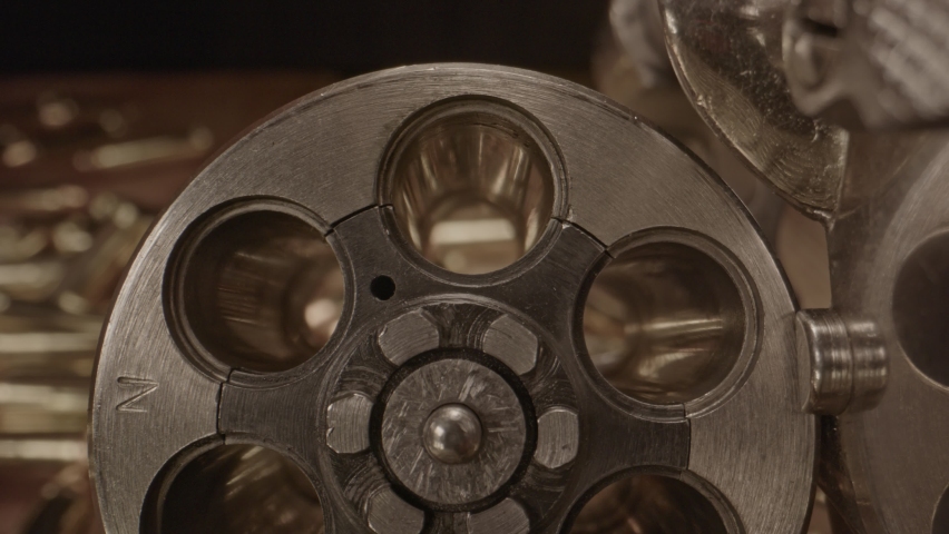 Amazing macro shot of hand loading .357 cartridges in old revolver cilinder