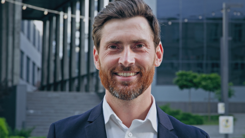 Headshot smiling positive bearded professional businessman in suit looking at camera standing on street confident successful handsome male entrepreneur manager leader posing outdoors business | Shutterstock HD Video #1093733787