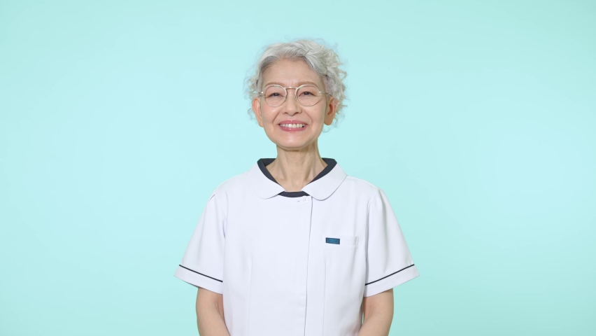 Elderly Asian woman wearing white robe.  Royalty-Free Stock Footage #1093739213