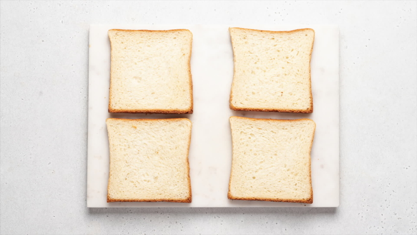 Stop motion animation of cooking toast. Set of various toasts on white background, top view. Mozzarella bruschetta, Hummus toast, peanut butter, peach and banana toasts. Healthy morning breakfast | Shutterstock HD Video #1093741847