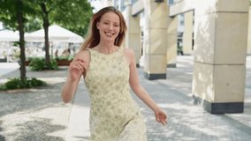 Young cheerful happy blonde woman model wearing dress walking jumping in summer city in slow motion. Smiling pretty blond lady tourist laughing and having fun going along urban street. - Powered by Shutterstock - Get 15% off with code: PIKWIZARD15