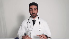 Arabian doctor taking consultation with video calling. Remote medicine. Telemedicine.