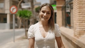 Young caucasian woman smiling confident walking at street